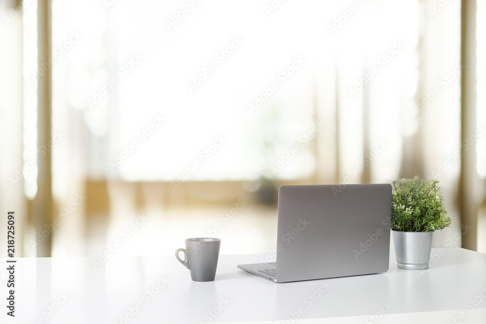 Workspace with laptop computer and coffee cup and plant, Stylish office desk work back view concept.