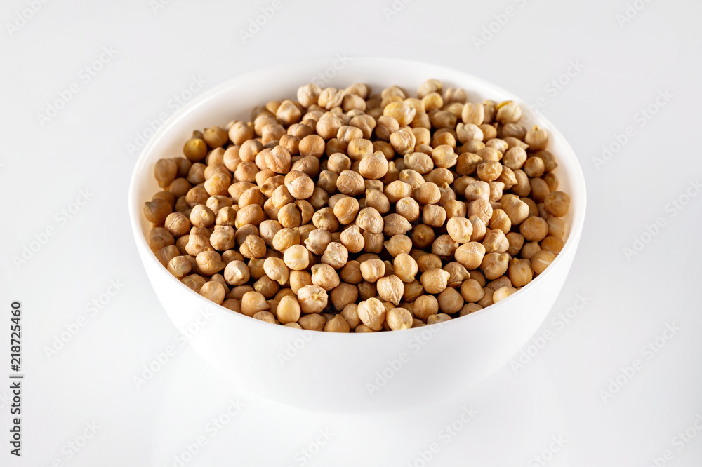 Closeup bowl of uncooked chickpeas isolated at white background. Closeup bowl of uncooked chickpeas isolated at white background.