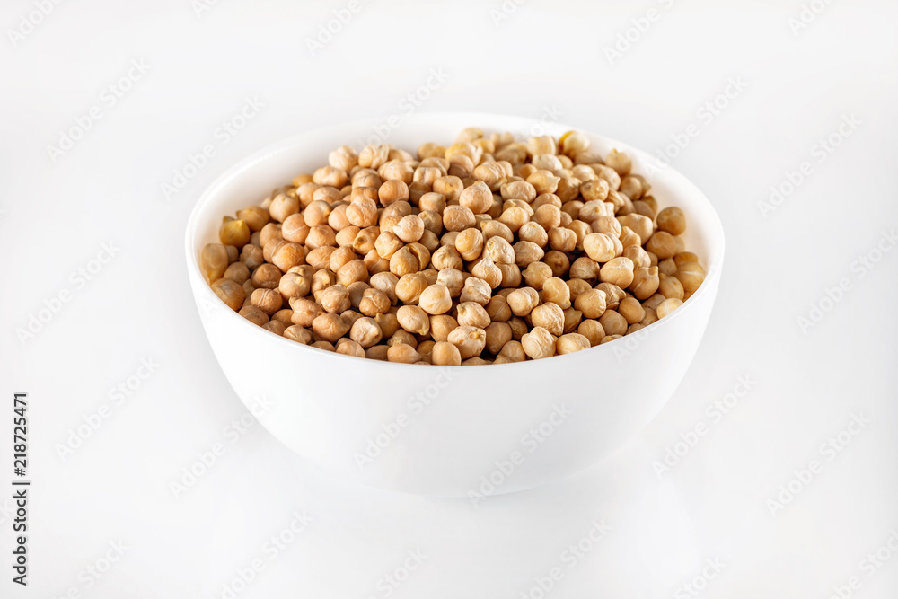 Closeup bowl of uncooked chickpeas isolated at white background. Closeup bowl of uncooked chickpeas isolated at white background.