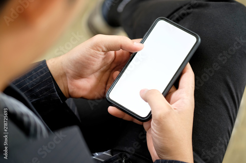 Cropped shot of an unrecognizable man using smartphone. Blank screen mobile phone for graphic display montage.