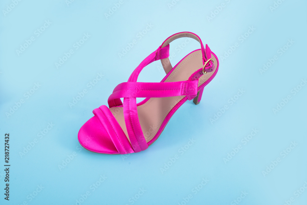 Female Pink shoes on light blue background Female Pink shoes on light blue background