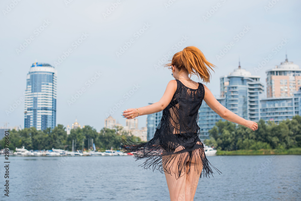 Naklejka premium Image of young amazing red hair attractive girl in sunglasses wearing black T-shirt with fringe on the yacht. Carefree time on yacht. Beautiful woman on her private yacht 