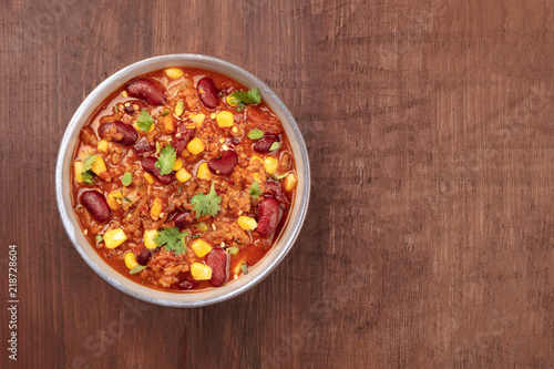 Chili con carne, traditional Mexican dish, overhead photo with copyspace