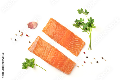 Slices of salmon with parsley, garlic and pepper, on a white background with copy space, overhead photo