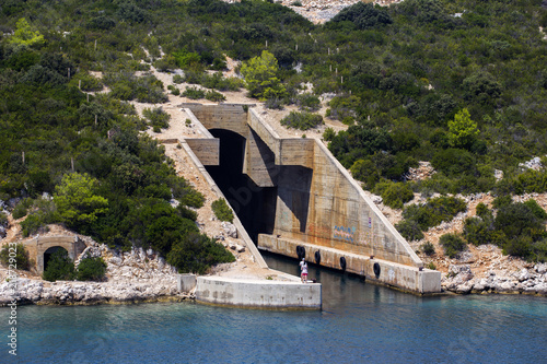 Tourists exploring ex military bunker for ships in Rogacic, Vis island - Croatia