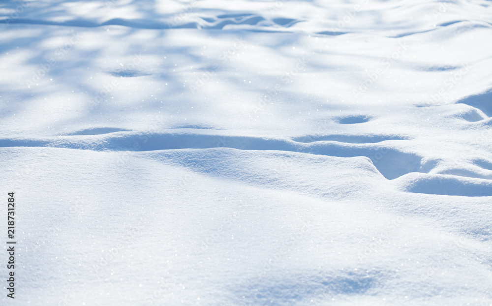 Beautiful snowy textured background, bluish colored snow abstract shape surface, close-up shallow depth of field.