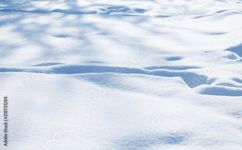 Beautiful snowy textured background, bluish colored snow abstract shape surface, close-up shallow depth of field.