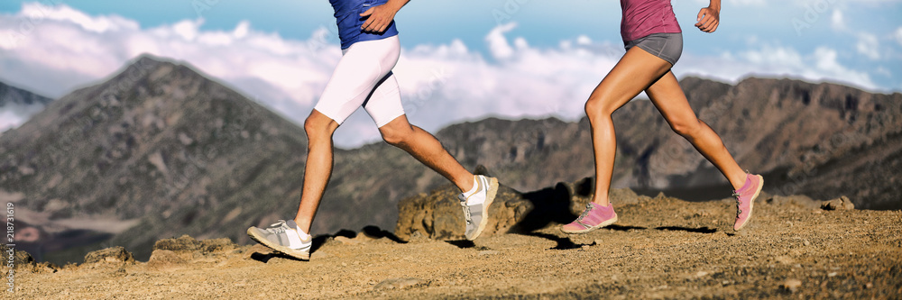 Trail running athletes legs of runners shoes and shorts, sportswear  cross-country running on volcano rocks difficult trail landscape. Banner  panorama. Woman and man lower body section closeup. Photos | Adobe Stock