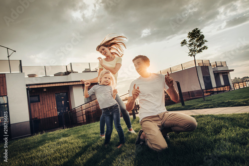 Obraz na plátně Full length portrait of optimistic lady flourishing hair while dancing with smiling little female child