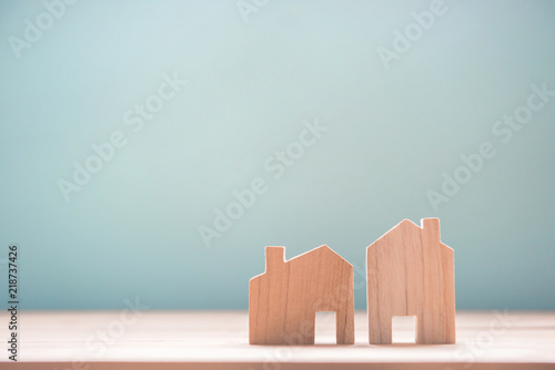 Close up diffirance two wood house model on blue background, Choose home the best for you, Planning to buy property.