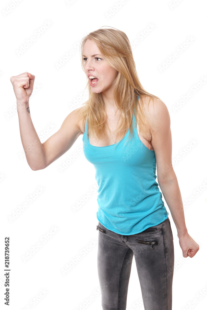 furious angry aggressive young woman screaming and threatening with clenched fist furious angry aggressive young woman screaming and threatening with clenched fist