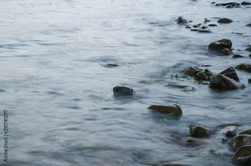 Long exposure photo of moving water and wet stones