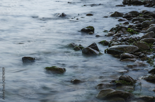 Long exposure photo of moving water and wet stones