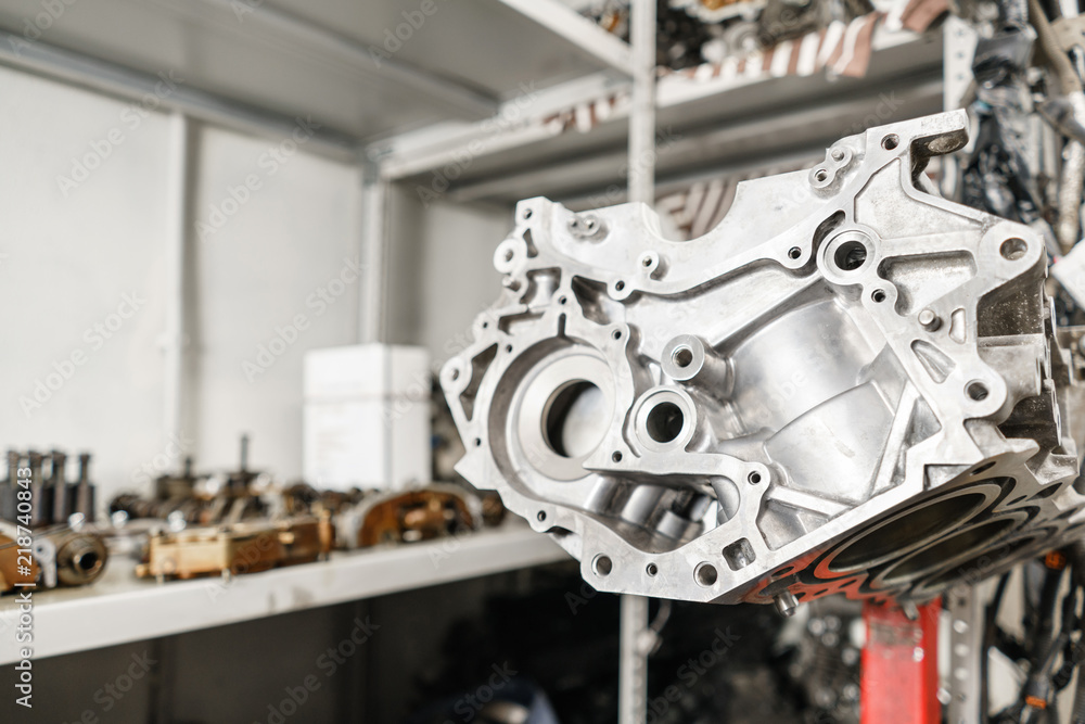The internal combustion engine, disassembled, repair at car service, overhaul. Repair at car service station. Neatly laid out on the table The internal combustion engine, disassembled, repair at car service, overhaul. Repair at car service station. Neatly laid out on the table