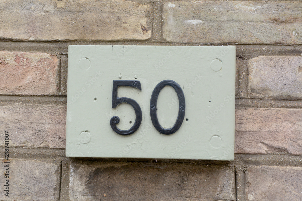 House number 50 sign fixed to wall House number 50 sign fixed to wall