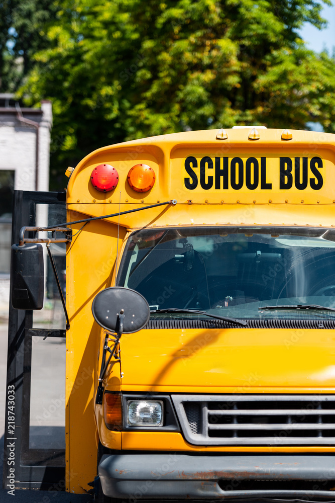 front view of traditional school bus with inscription over front glass