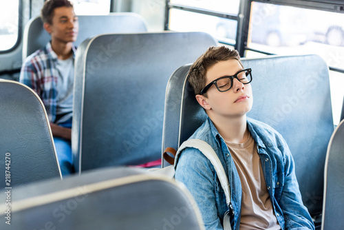 multiethnic teen schoolboys riding school bus © LIGHTFIELD STUDIOS