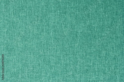 Turquoise canvas texture for background with visible fibers. 