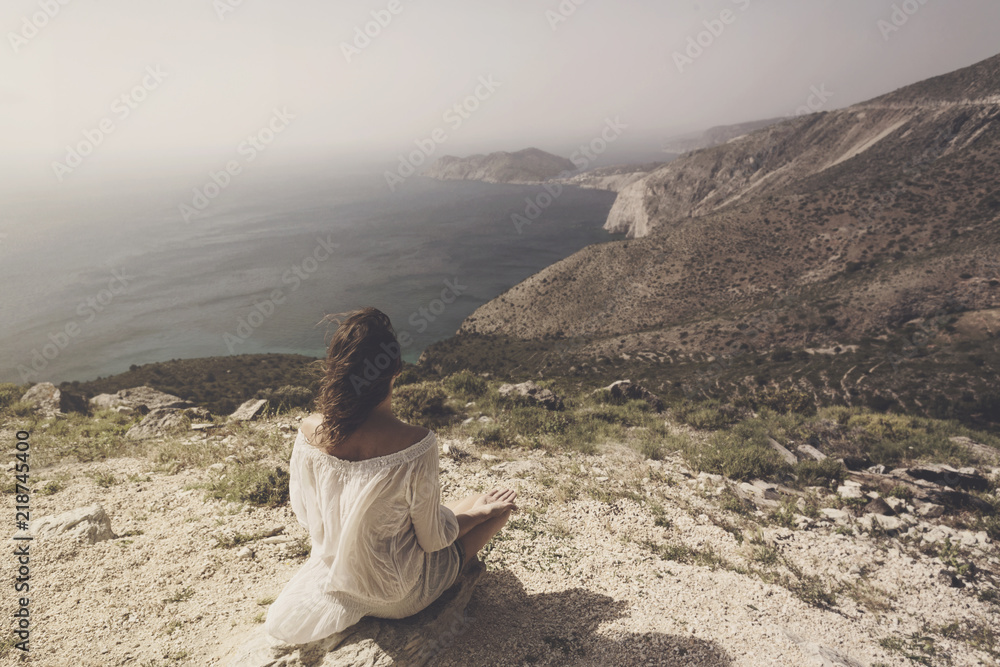 woman doing yoga exercises in front of a spectacular view