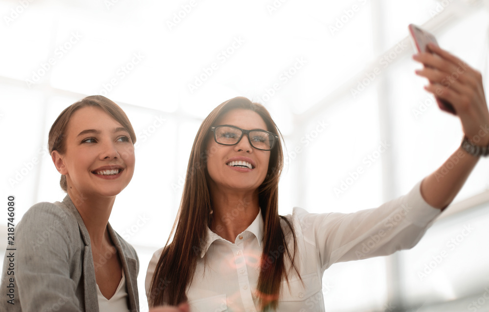 business colleagues take selfies in a bright office business colleagues take selfies in a bright office