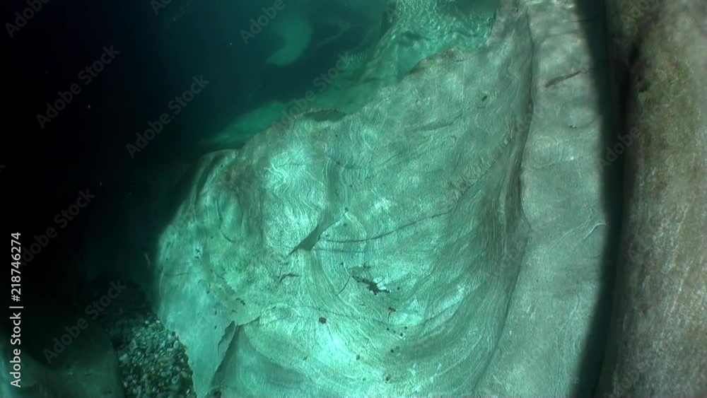 Huge smooth stones and rocks underwater of clear turquoise river Verzasca. Picturesque nature and beautiful landscape in canton of Ticino are favorite place for underwater photographers. Huge smooth stones and rocks underwater of clear turquoise river Verzasca. Picturesque nature and beautiful landscape in canton of Ticino are favorite place for underwater photographers.