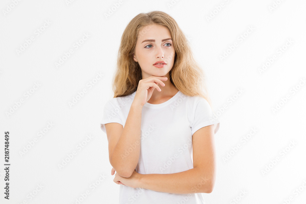 Thinking young caucasian blonde woman isolated on white background. European girl in t shirt with perfect face and skin care concept. Copy space Thinking young caucasian blonde woman isolated on white background. European girl in t shirt with perfect face and skin care concept. Copy space