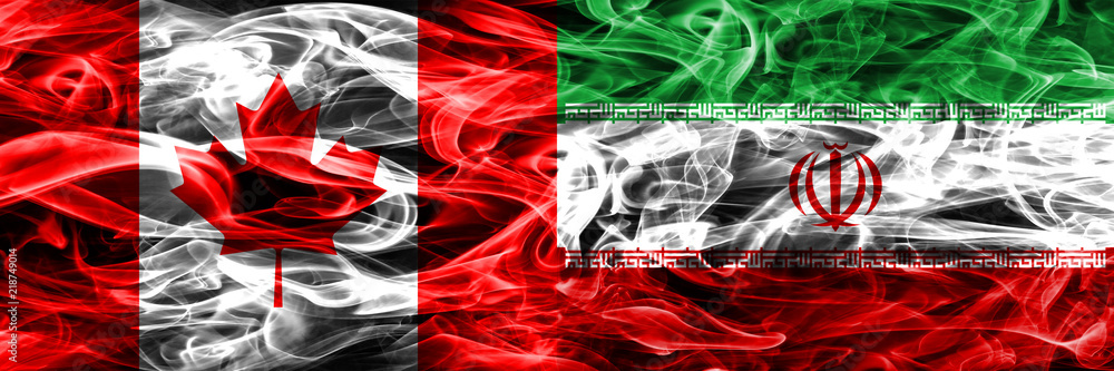 Obraz premium Canada vs Iran smoke flags placed side by side. Canadian and Iran flag together