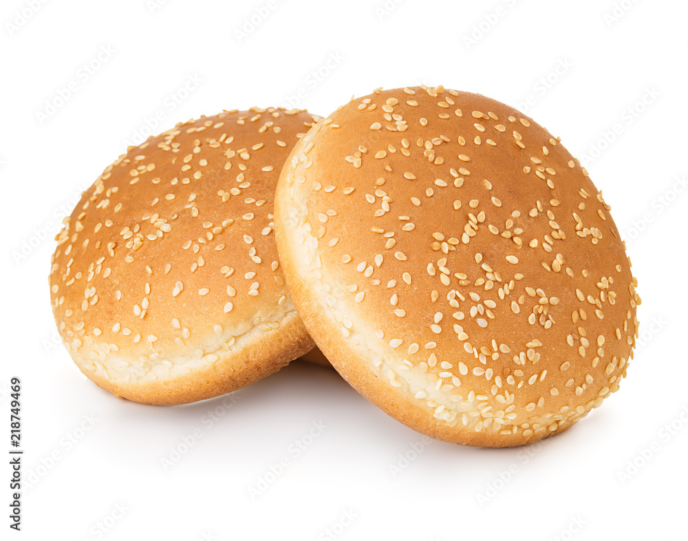 Two hamburger buns with sesame isolated on white background. Two hamburger buns with sesame isolated on white background.