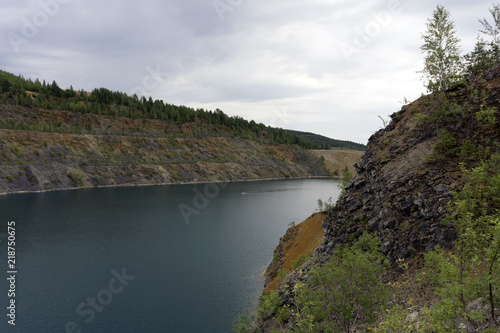 lake with blue water, a place of recreation formed on the site of old abandoned quarry