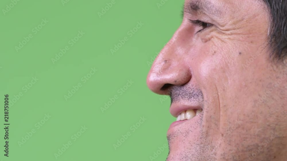 Close-up side view of Hispanic man smiling Close-up side view of Hispanic man smiling