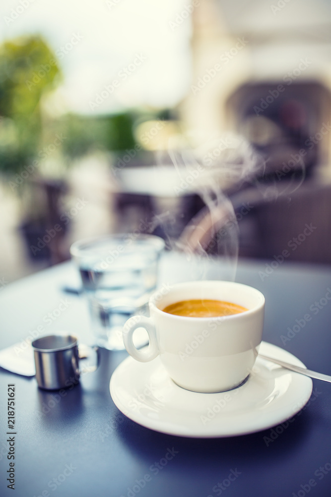 Cup of coffee on table in restaurant terrace