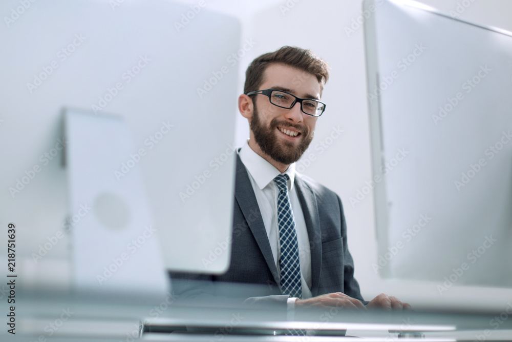 businessman working on a computer sitting at his Desk
