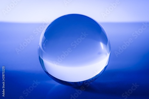 Glass ball in abstract blue