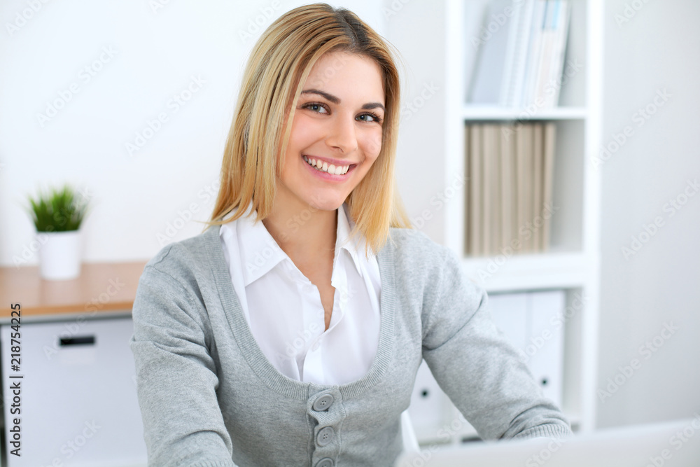 Young business woman or student girl working at office workplace with laptop computer Young business woman or student girl working at office workplace with laptop computer