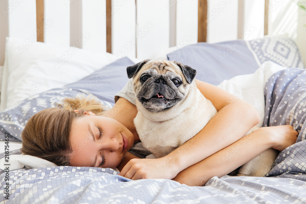Young woman with her dog in a bed. Breakfast in bed Young woman with her dog in a bed. Breakfast in bed