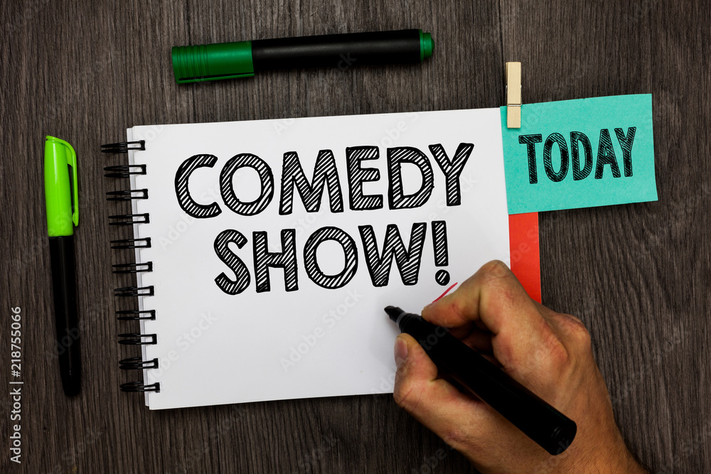 Conceptual hand writing showing Comedy Show. Business photo showcasing Funny program Humorous Amusing medium of Entertainment Man holding marker notebook reminder cup markers wood table.
