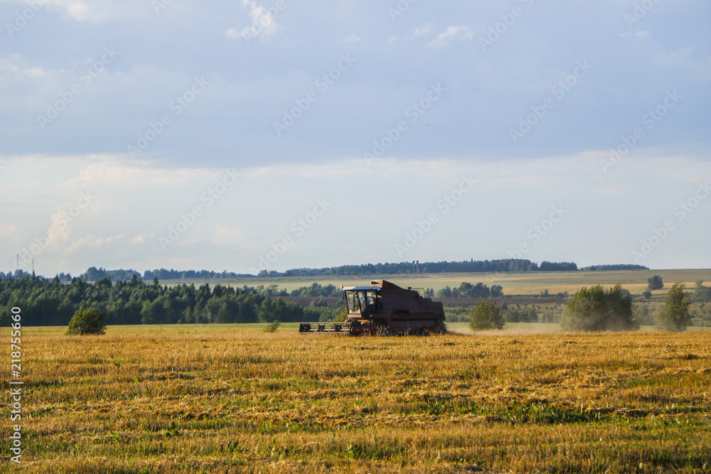 Combine harvester. old combine harvester working on the wheat field Kombain collects on the wheat crop. Agricultural machinery in the field.