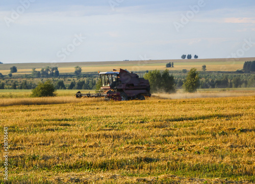 Combine harvester. old combine harvester working on the wheat field Kombain collects on the wheat crop. Agricultural machinery in the field. © Оксана Скиданова