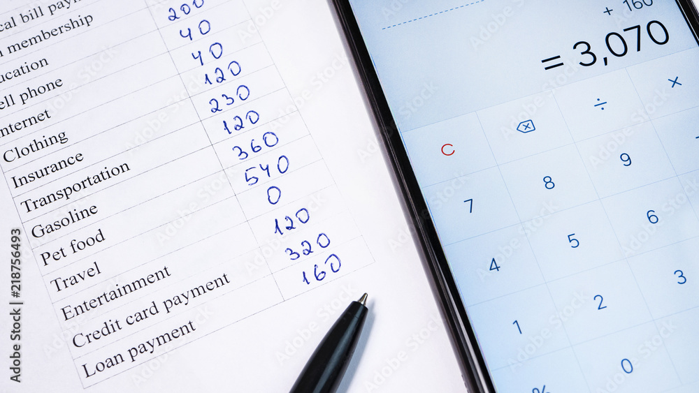Home budget planning sheet with pen and smart phone calculator Home budget planning sheet with pen and smart phone calculator