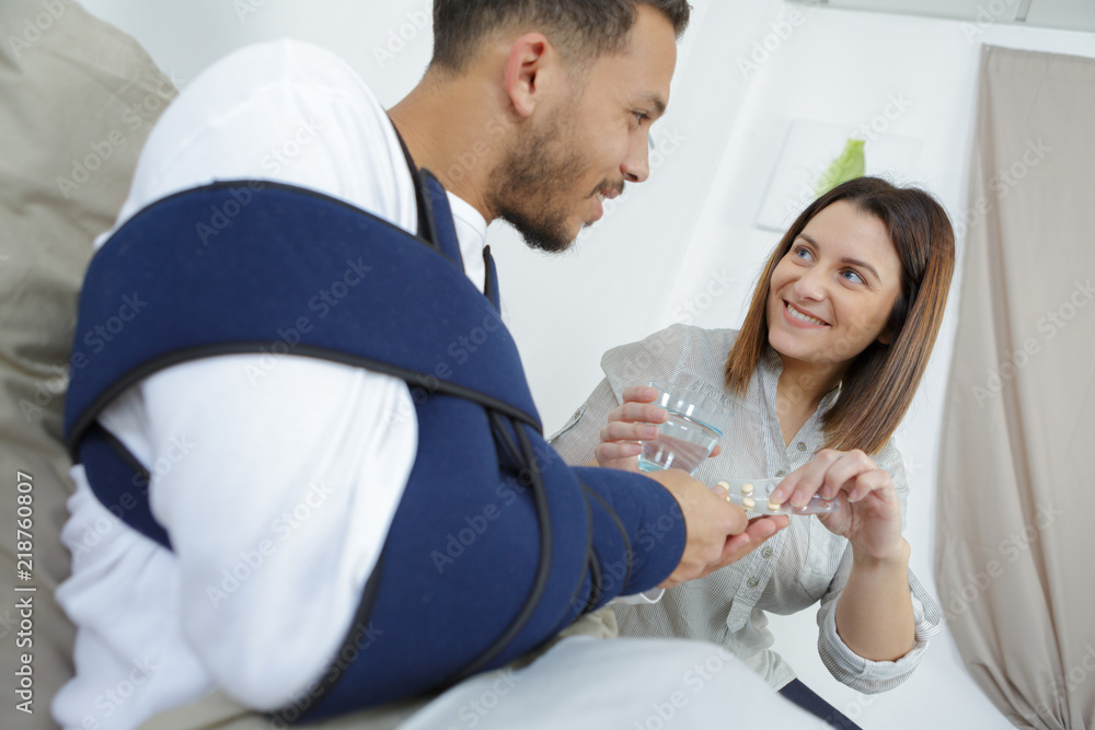wife giving medication to husband wife giving medication to husband