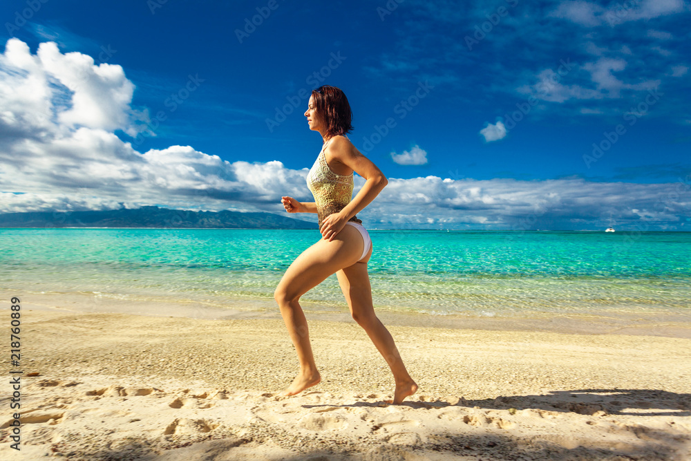 Young woman enjoying tropical beach holidays at Moorea, French Polynesia Young woman enjoying tropical beach holidays at Moorea, French Polynesia