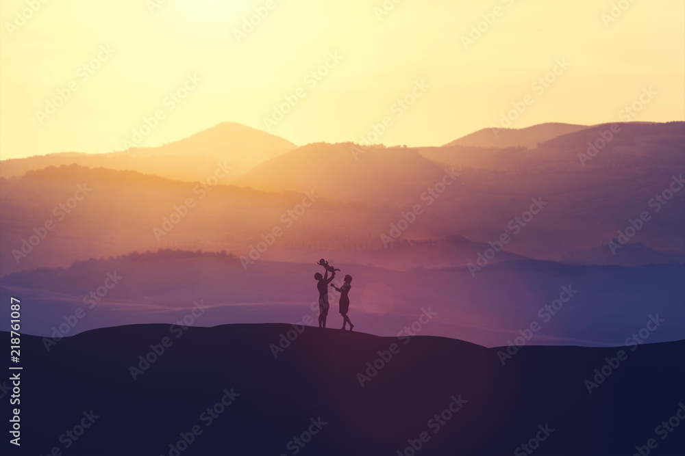 Happy parents playing with the baby on the hills. Happy parents playing with the baby on the hills.