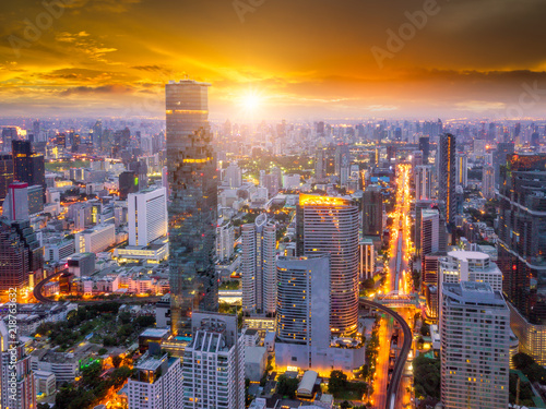 Aerial view of Bangkok skyline and skyscraper on Silom road center of business in capital. Modern city and BTS skytrain with Chao Phraya river at Bangkok Thailand on sunrise © Travel man