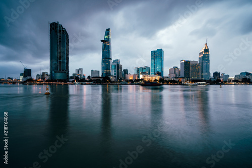 Fototapeta Naklejka Na Ścianę i Meble -  Beautiful view of Ho Chi Minh City skyline and skyscrapers in center of heart business at Ho Chi Minh City downtown. Panorama of cityscape on Saigon river in Ho Chi Minh City at Vietnam at sunset 