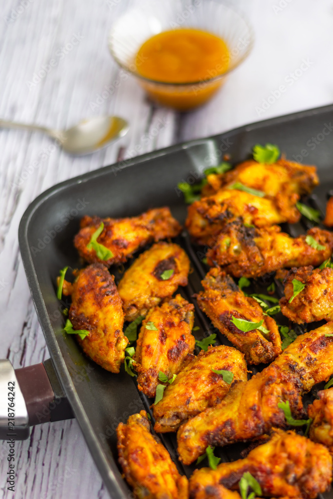 Fototapeta premium Spicy Chicken Wings Served with Cilantro