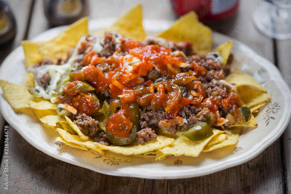 Chilli beef nachos with salsa, jalapeños & grated cheese Chilli beef nachos with salsa, jalapeños & grated cheese