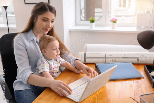 Young woman with baby worki...
