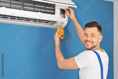 Electrician measuring volta...
