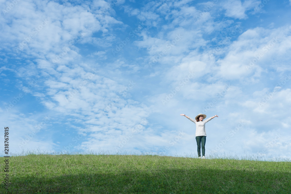 Standing woman raised her hands on the mountain, natural green and beautiful sky. Standing woman raised her hands on the mountain, natural green and beautiful sky.
