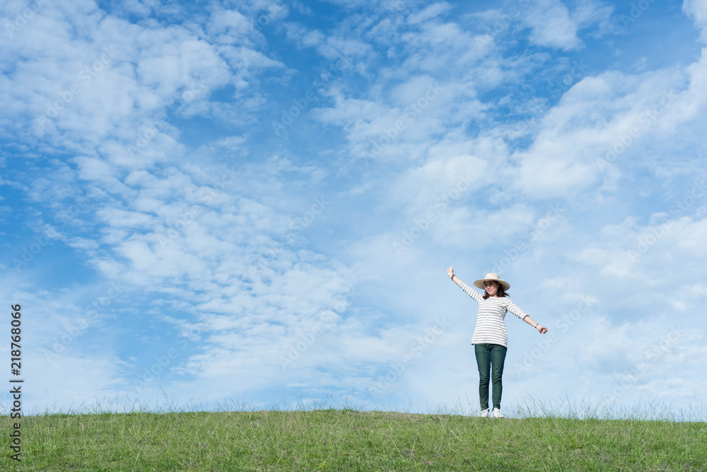 Standing woman raised her hands on the mountain, natural green and beautiful sky. Standing woman raised her hands on the mountain, natural green and beautiful sky.